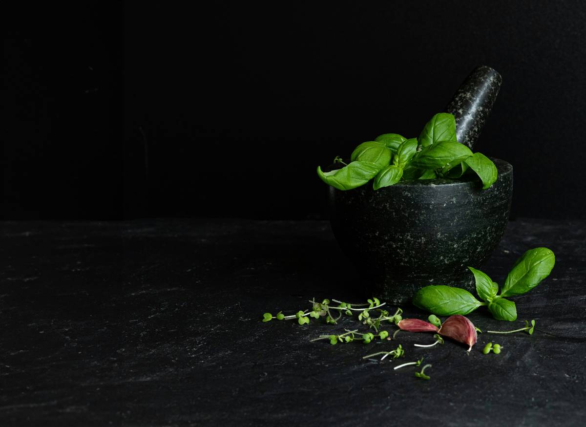 Traditional Medicine herbal skincare preparation with dried botanicals and clay bowls