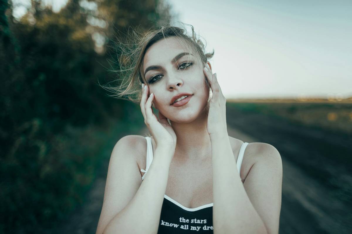 Woman applying herbal face mask with Natural Immunity focus
